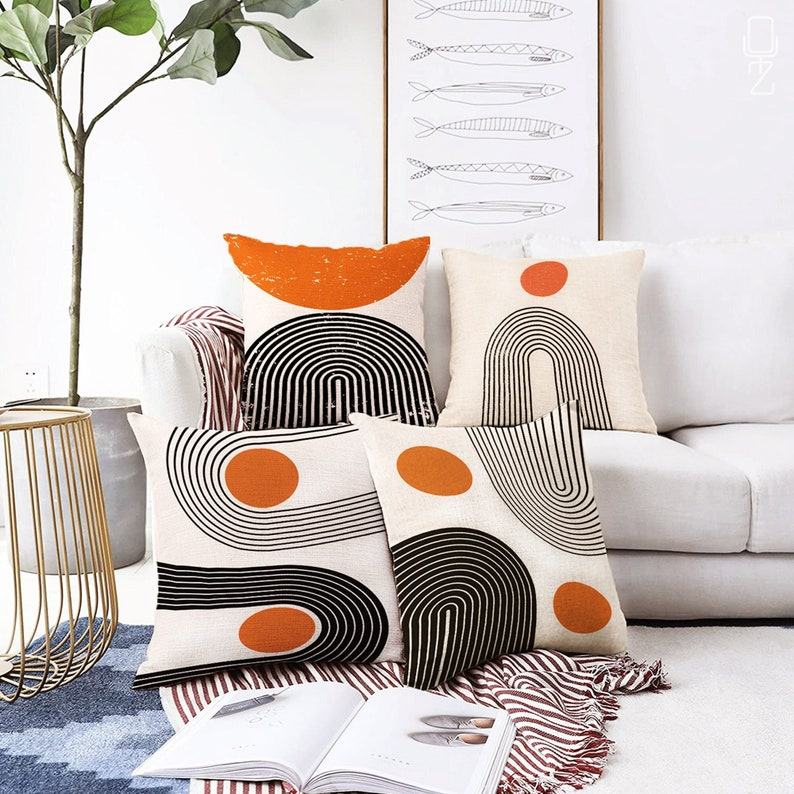Abstract Ivory Cushion Cover Designs with Vibrant Orange Accents