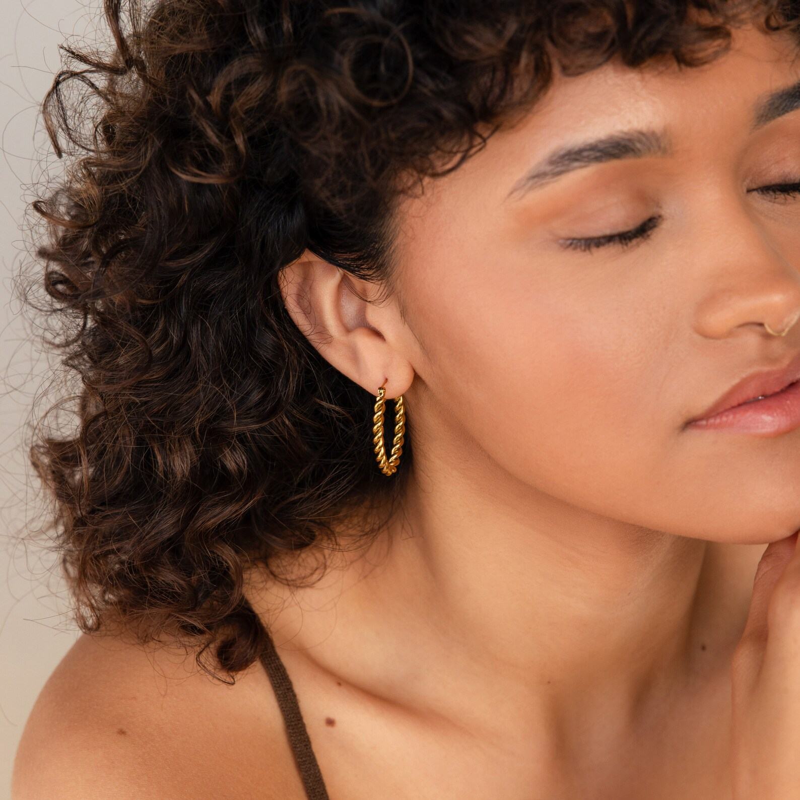 Bold and Twisted Elevate Your Style with Caitlyn’s Minimalist Statement Hoops