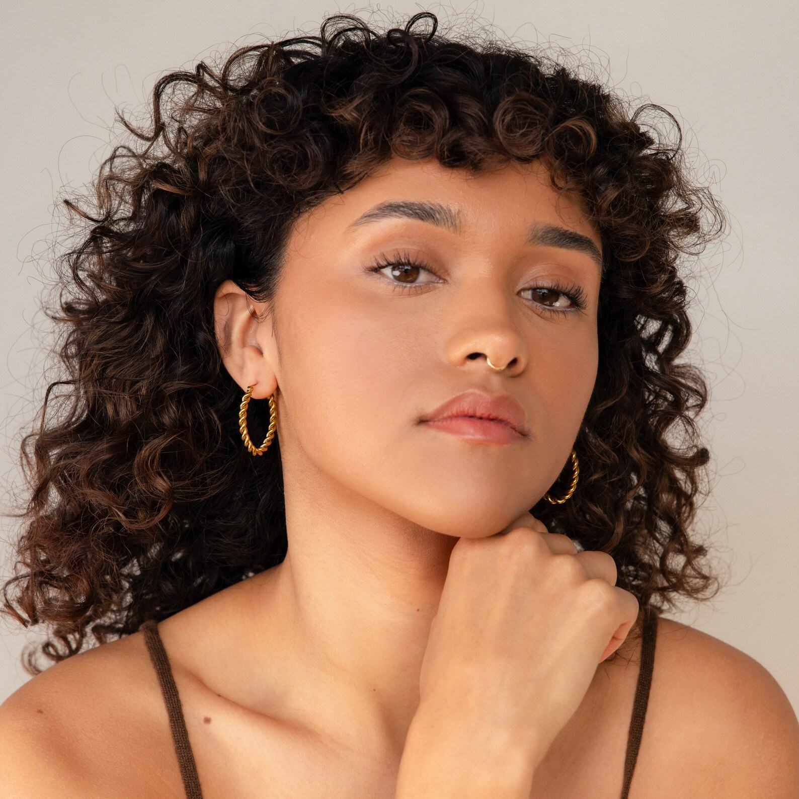 Bold and Twisted Elevate Your Style with Caitlyn’s Minimalist Statement Hoops