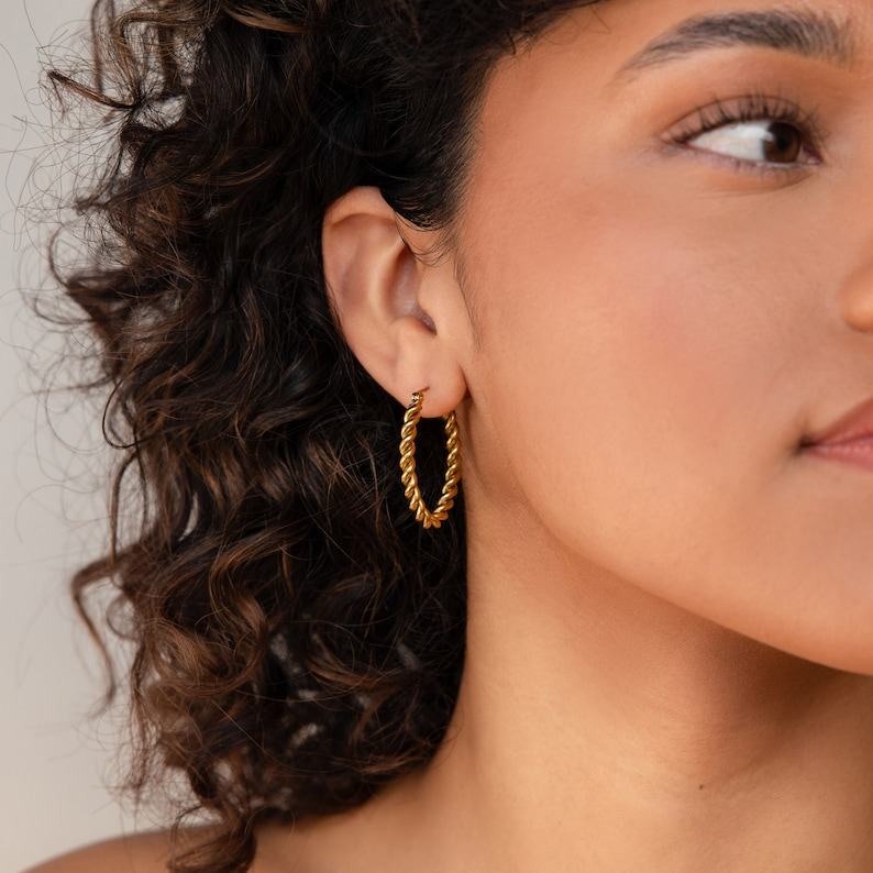 Bold and Twisted Elevate Your Style with Caitlyn’s Minimalist Statement Hoops