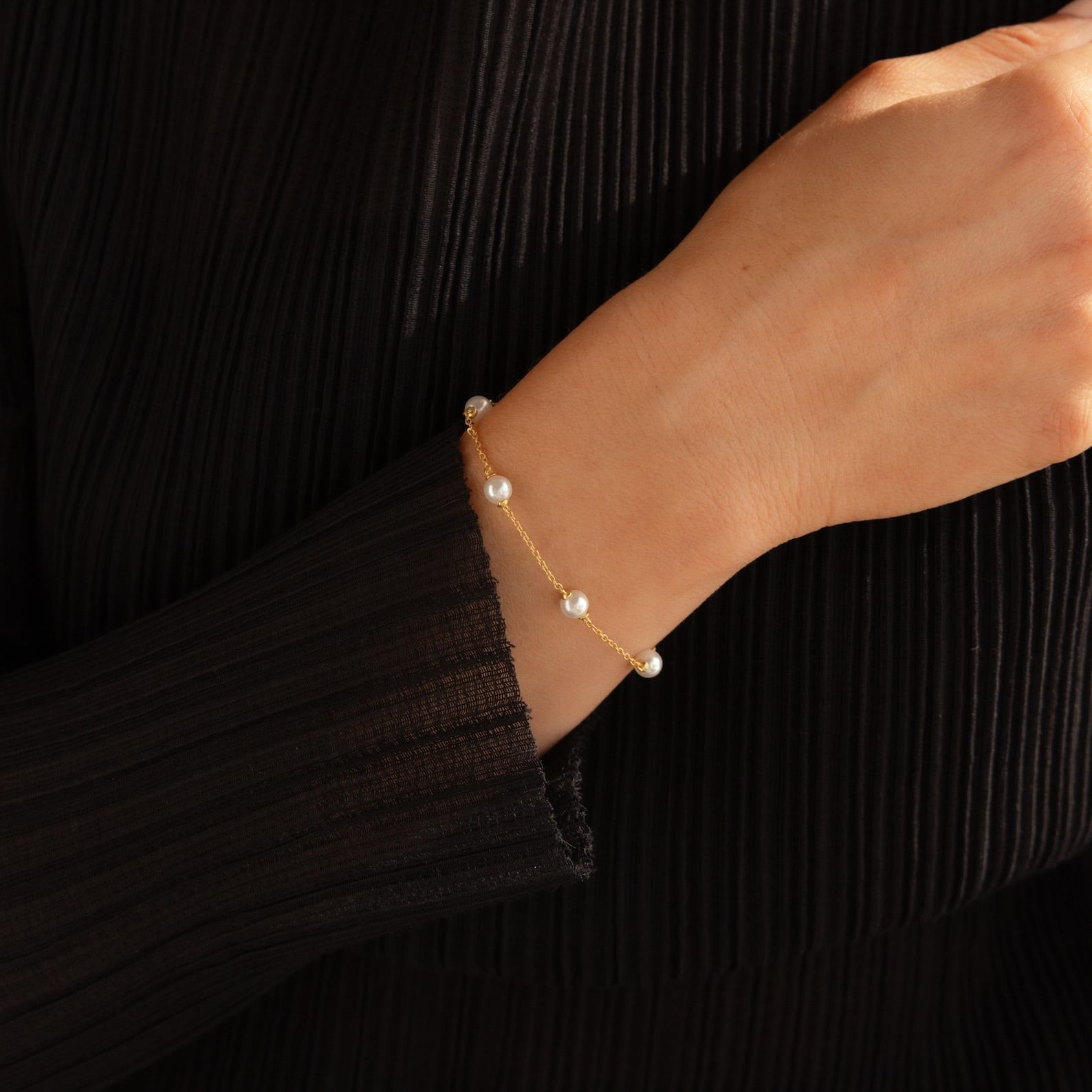Caitlyn Minimalist’s Pearl Station Bracelet A Delicate Charm of Pearls and Gold