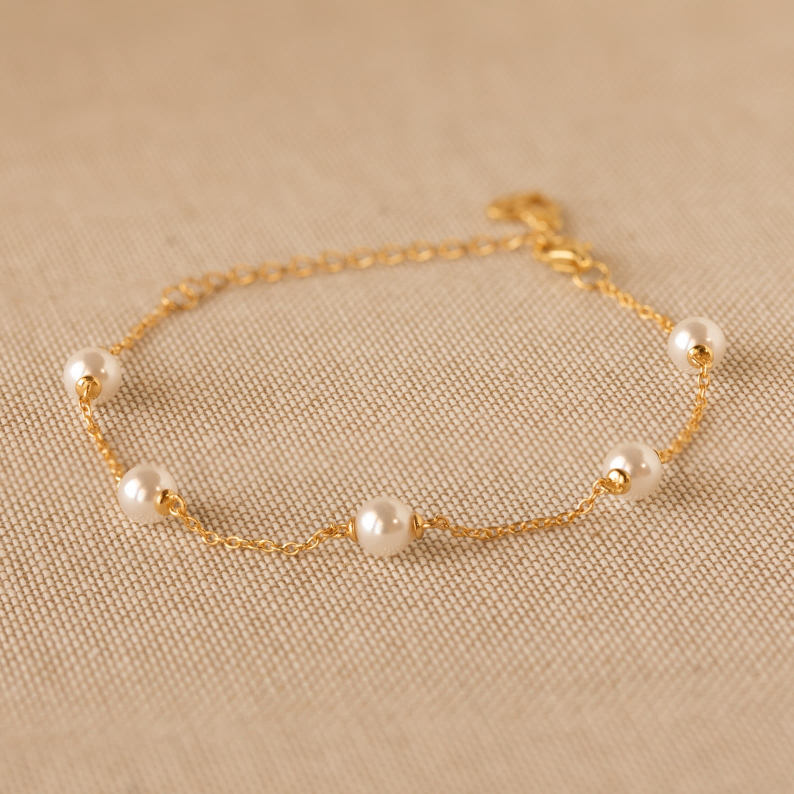 Caitlyn Minimalist’s Pearl Station Bracelet A Delicate Charm of Pearls and Gold