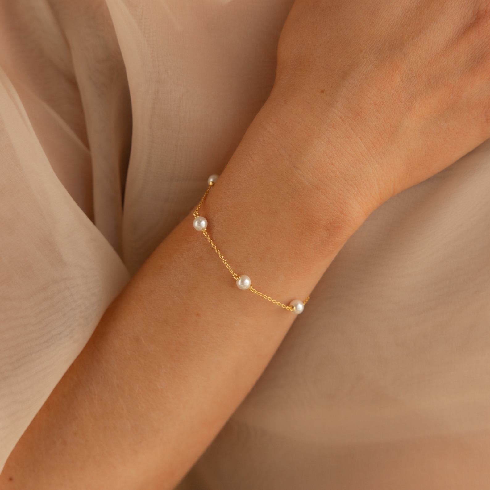 Caitlyn Minimalist’s Pearl Station Bracelet A Delicate Charm of Pearls and Gold