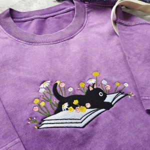 Cozy Cat on a Literary Adventure Embroidered T-shirt for Bookworms and Feline Enthusiasts