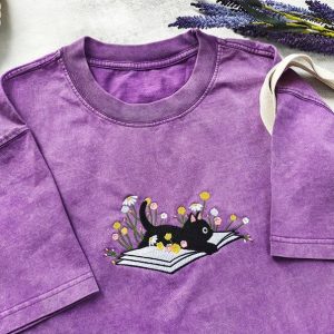 Cozy Cat on a Literary Adventure Embroidered T-shirt for Bookworms and Feline Enthusiasts