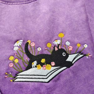Cozy Cat on a Literary Adventure Embroidered T-shirt for Bookworms and Feline Enthusiasts