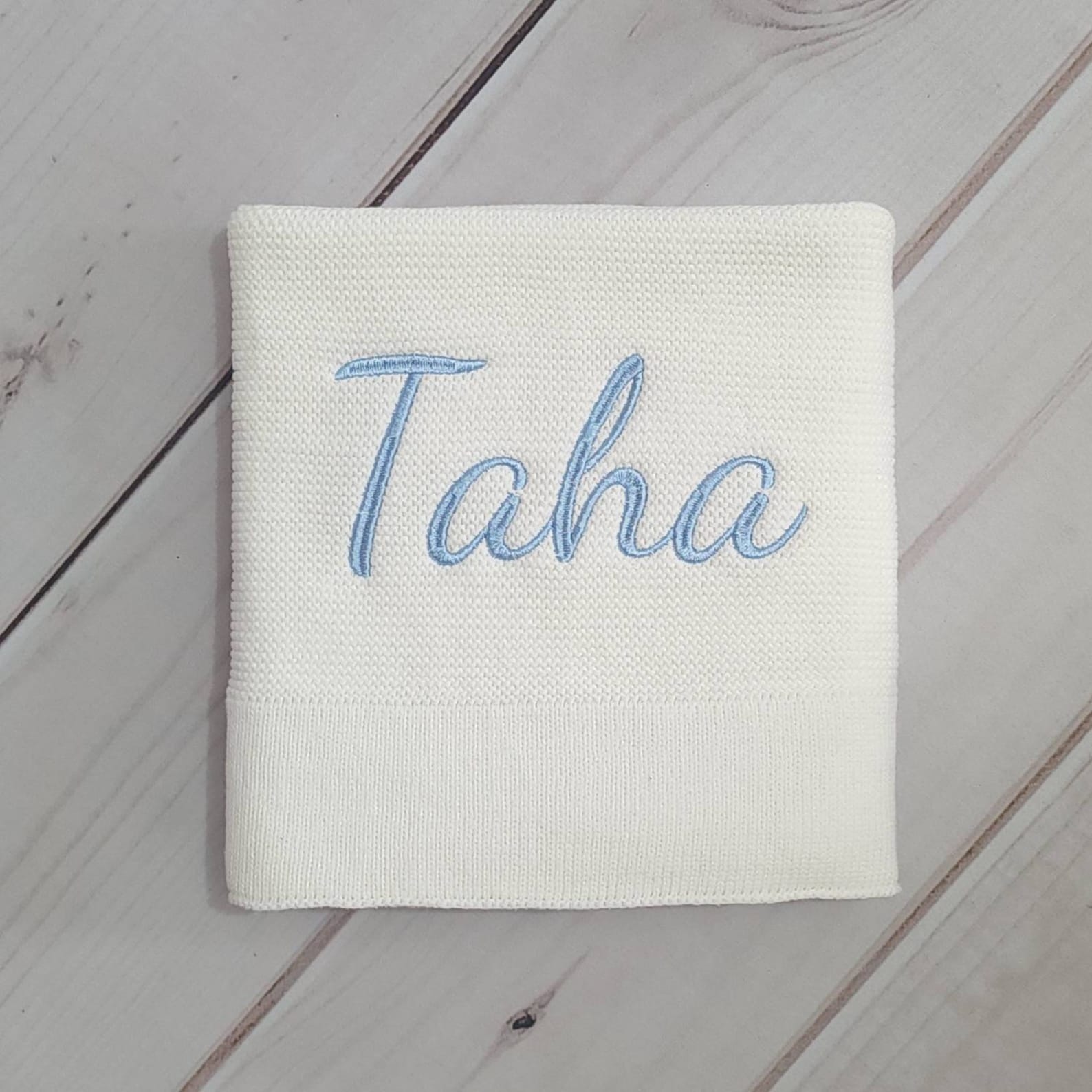 Cozy Comfort for Little Ones Off-White Knitted Baby Blanket with Embroidered Charm