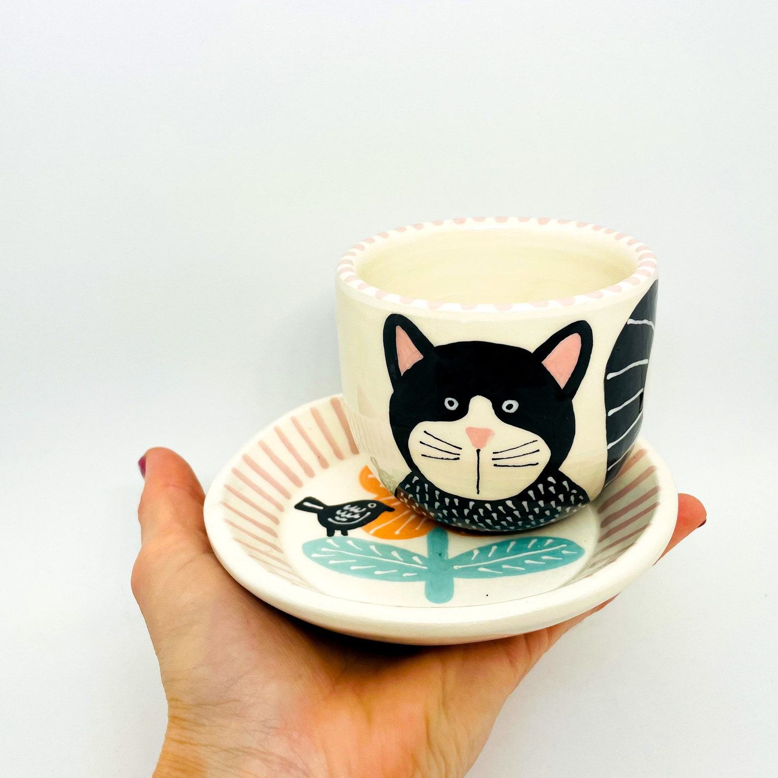 Enchanting Ceramic Cup and Saucer A Feline Fantasy with a Bird and Bloom
