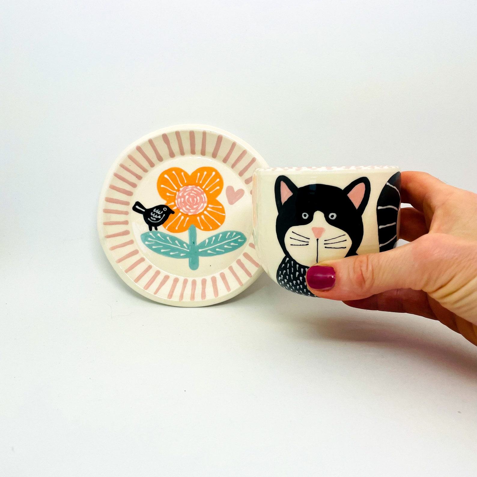 Enchanting Ceramic Cup and Saucer A Feline Fantasy with a Bird and Bloom