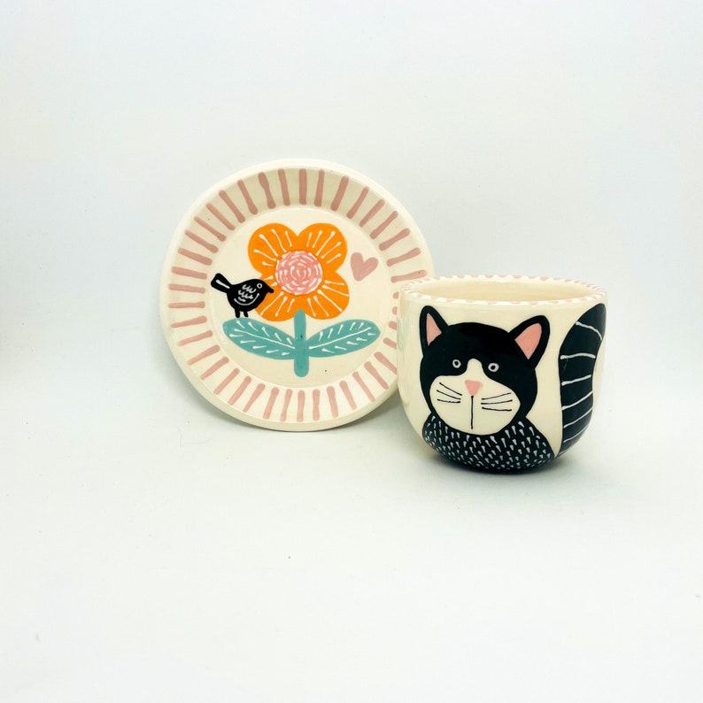 Enchanting Ceramic Cup and Saucer A Feline Fantasy with a Bird and Bloom