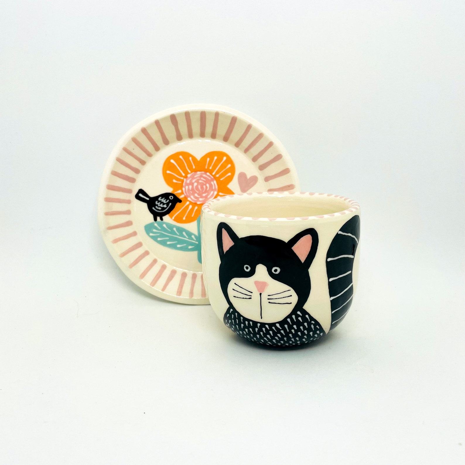 Enchanting Ceramic Cup and Saucer A Feline Fantasy with a Bird and Bloom