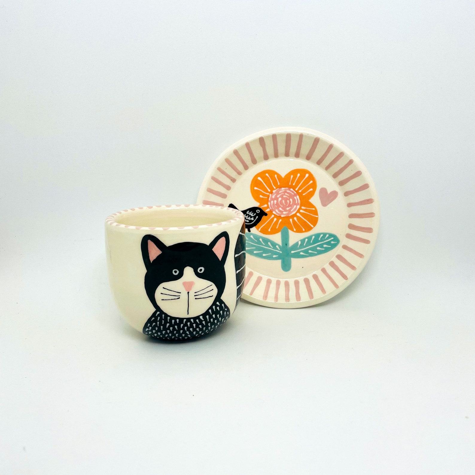 Enchanting Ceramic Cup and Saucer A Feline Fantasy with a Bird and Bloom