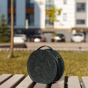 Exquisite Handmade Round Leather Bag with Intricate Flower Embossing