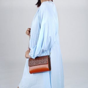 Exquisitely Crafted Orange Leather Sling Bag A Symphony of Teak Wood and Hand-Tooled Art