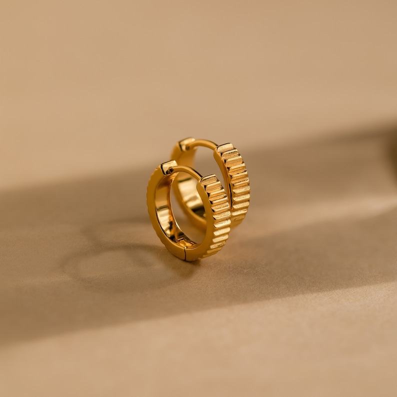 Golden Embrace Ribbed Huggie Hoops for a Timeless Allure