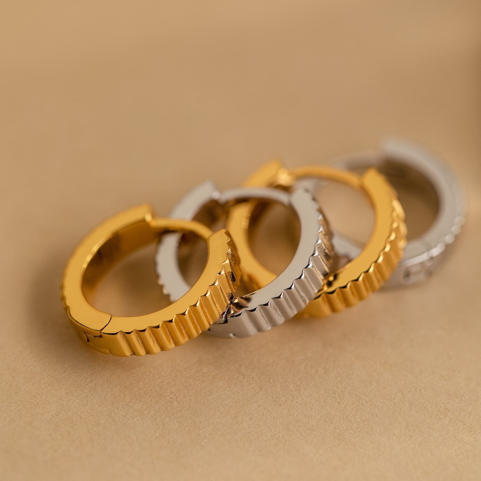 Golden Embrace Ribbed Huggie Hoops for a Timeless Allure