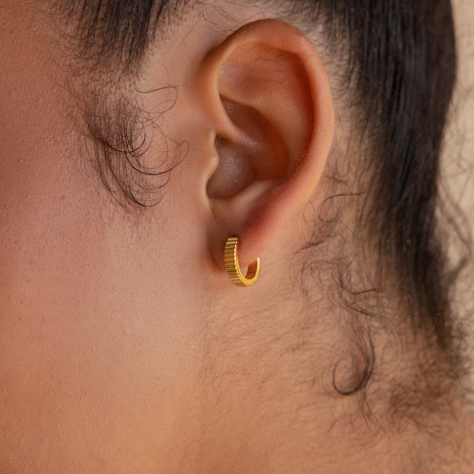 Golden Embrace Ribbed Huggie Hoops for a Timeless Allure