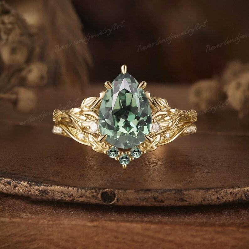 Nature’s Embrace Vintage Pear Cut Green Sapphire Engagement Ring Set with Leaf-Inspired Wedding Band