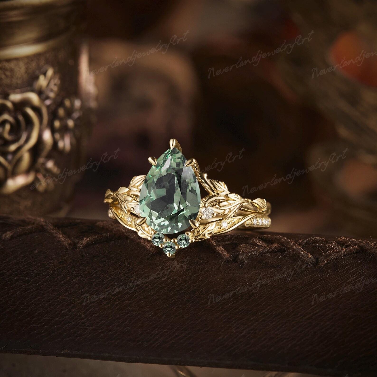 Nature’s Embrace Vintage Pear Cut Green Sapphire Engagement Ring Set with Leaf-Inspired Wedding Band