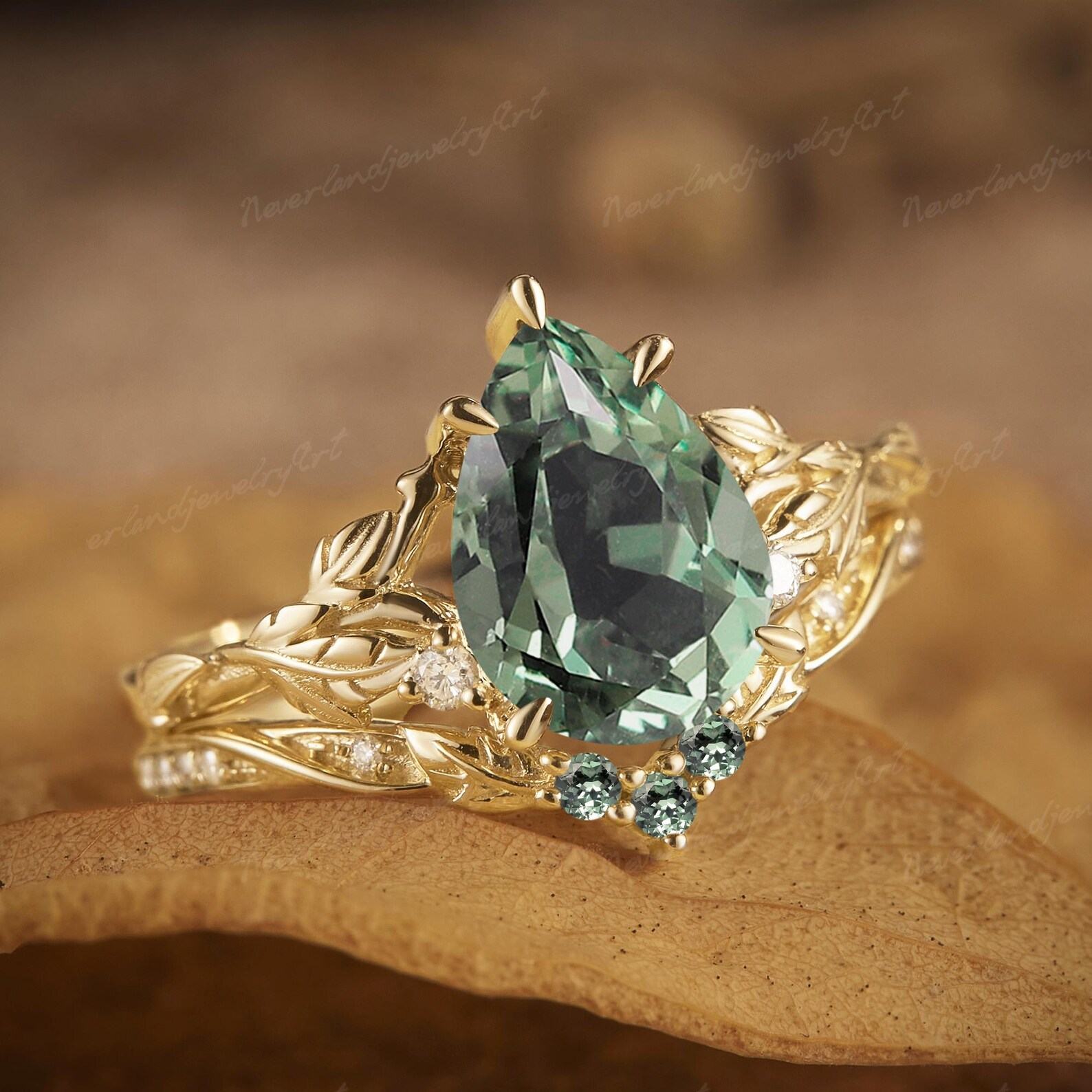 Nature’s Embrace Vintage Pear Cut Green Sapphire Engagement Ring Set with Leaf-Inspired Wedding Band
